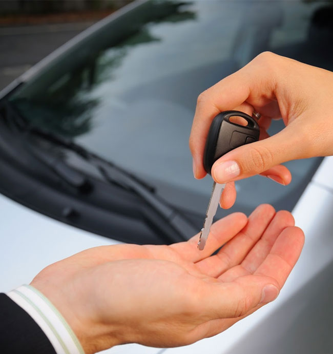 The exchange of a car key between two individuals signifies quick cash for cars in Brisbane.