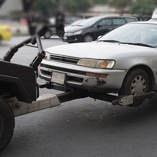 A car being towed by a tow truck, symbolizing the Top Cash for old Cars in Brisbane vehicle removal service.